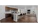 Open concept kitchen featuring a large island with seating and dark wood cabinets at 39743 Penn Rd, Elizabeth, CO 80107