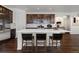 Bright eat-in kitchen with stainless steel appliances, island with chairs, and modern fixtures at 39743 Penn Rd, Elizabeth, CO 80107