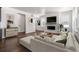 Bright living room with a fireplace, media center, comfortable seating, and view of backyard at 39743 Penn Rd, Elizabeth, CO 80107