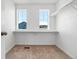 Spacious walk-in closet with shelving and natural light from two windows at 39743 Penn Rd, Elizabeth, CO 80107