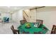 Open finished basement with barn door access, game table, access to the stairway, and a carpeted floor at 8622 W Warren Ln, Lakewood, CO 80227