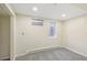 Basement bedroom with carpet, two windows, baseboard heat, and neutral paint color at 8622 W Warren Ln, Lakewood, CO 80227