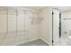 Walk-in closet with wire shelving, carpet, and a view into an adjacent bathroom with tiled floors at 8622 W Warren Ln, Lakewood, CO 80227