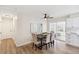 Bright dining area with modern table, stylish chairs, and sliding door access to the patio at 8622 W Warren Ln, Lakewood, CO 80227