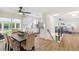 Open concept view of dining room with patio access, modern kitchen, and staircase at 8622 W Warren Ln, Lakewood, CO 80227