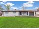 Charming single-story home with a well-manicured lawn, and a one car garage at 8622 W Warren Ln, Lakewood, CO 80227