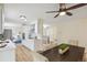 Modern eat-in kitchen with white cabinets, stone countertops, wood floors, and stainless appliances at 8622 W Warren Ln, Lakewood, CO 80227