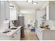 Modern kitchen with white cabinets, stone countertops, and stainless steel appliances at 8622 W Warren Ln, Lakewood, CO 80227