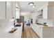 Modern kitchen featuring white cabinets, stainless steel appliances, and quartz countertops at 8622 W Warren Ln, Lakewood, CO 80227