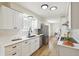 Bright kitchen featuring white cabinets, stone countertops, and stainless steel appliances at 8622 W Warren Ln, Lakewood, CO 80227