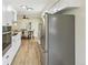 Modern kitchen features stainless appliances, eat-in space, and wood floors at 8622 W Warren Ln, Lakewood, CO 80227