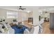 Open-concept living room featuring wood floors, lots of seating, and lots of natural light at 8622 W Warren Ln, Lakewood, CO 80227