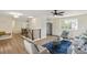 Spacious living room featuring wood floors, modern staircase, and a ceiling fan at 8622 W Warren Ln, Lakewood, CO 80227