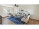 Inviting living room showcasing wood floors, a comfy sofa, and lots of natural light at 8622 W Warren Ln, Lakewood, CO 80227