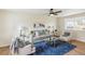 Comfortable living room with wood floors, a stylish sofa, and a ceiling fan at 8622 W Warren Ln, Lakewood, CO 80227
