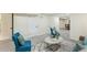 Spacious finished basement living area with an accent chair, carpeted floor, and a decorative throw rug at 8622 W Warren Ln, Lakewood, CO 80227