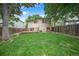 Spacious backyard features a lush lawn, deck, and privacy fence perfect for outdoor activities and relaxation at 5602 S Yank Ct, Littleton, CO 80127