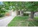 Charming home with a well-kept lawn, mature trees, and a welcoming front entrance at 5602 S Yank Ct, Littleton, CO 80127
