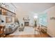Comfortable living room with vaulted ceiling, wood floors, fireplace, and a second-story loft with wood railing at 5602 S Yank Ct, Littleton, CO 80127
