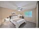 Cozy bedroom featuring a ceiling fan, plush carpeting, a large window, and neutral decor that offers a relaxing retreat at 5602 S Yank Ct, Littleton, CO 80127