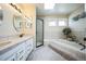 Luxurious Primary bathroom with dual sinks, a walk-in shower, and a jetted soaking tub at 6275 Lakewood Rd, Parker, CO 80134