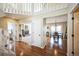 Bright foyer with hardwood floors, staircase, and views to the formal living room and dining room at 6275 Lakewood Rd, Parker, CO 80134