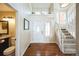 Inviting foyer with hardwood floors, staircase, and a convenient powder room at 6275 Lakewood Rd, Parker, CO 80134
