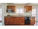 The kitchen features wood cabinets, a stainless steel microwave, and tile countertops at 6275 Lakewood Rd, Parker, CO 80134