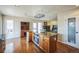 Eat-in kitchen featuring an island with an oven and cooktop and views to the Gathering room at 6275 Lakewood Rd, Parker, CO 80134