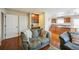Cozy living room with view of kitchen features wood floors, and natural light at 6275 Lakewood Rd, Parker, CO 80134