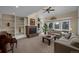 Inviting living room with a brick fireplace, large windows, and comfortable seating at 6275 Lakewood Rd, Parker, CO 80134