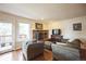 Comfortable living room features a brick fireplace, hardwood floors, and access to the deck at 6275 Lakewood Rd, Parker, CO 80134
