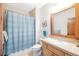 Classic bathroom featuring a shower with striped curtain, tile floors, and wood mirror at 186 Rachel Ln, Breckenridge, CO 80424