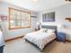 Cozy bedroom featuring a queen bed, carpet, and a window with natural wood trim at 186 Rachel Ln, Breckenridge, CO 80424