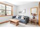 Cozy living space featuring a modern sofa, unique wood coffee table, and scenic outdoor views at 186 Rachel Ln, Breckenridge, CO 80424