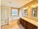 Primary bathroom with a soaking tub, double vanity, and a walk-in shower at 9821 Mobile St, Commerce City, CO 80022