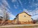 Tan two-story house with wooden fence and backyard at 9821 Mobile St, Commerce City, CO 80022