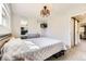 Bedroom with neutral palette and decorative mirror offers a serene and relaxing atmosphere at 3225 S Garrison St # 9, Lakewood, CO 80227
