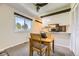 Bright dining area with a window and wood table next to kitchen with stainless steel appliances at 3225 S Garrison St # 9, Lakewood, CO 80227