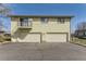 Building with garages, a balcony, and yellow siding at 3225 S Garrison St # 9, Lakewood, CO 80227