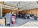 View of a cluttered garage with bikes and a motorcycle at 3225 S Garrison St # 9, Lakewood, CO 80227