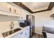 Kitchen area showcasing stainless steel appliances, bright countertops, and custom wood accent at 3225 S Garrison St # 9, Lakewood, CO 80227