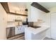 Modern kitchen featuring white cabinets, stainless steel appliances, and a sleek countertop at 3225 S Garrison St # 9, Lakewood, CO 80227
