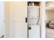 Cozy laundry area with a stacked washer and dryer, and barn door at 3225 S Garrison St # 9, Lakewood, CO 80227