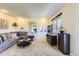 Bright living room with a gray sectional, large windows, and contemporary decor, perfect for relaxing at 3225 S Garrison St # 9, Lakewood, CO 80227