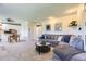 Open-concept living space with a comfortable sofa, stylish decor, and seamless flow to the dining area at 3225 S Garrison St # 9, Lakewood, CO 80227