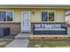 Inviting porch area with a comfortable outdoor sofa, creating a welcoming entrance to the home at 3225 S Garrison St # 9, Lakewood, CO 80227