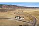Scenic aerial view showcasing luxury homes in a picturesque setting with mountains and winding roads at 5741 Doc Bar Circle, Larkspur, CO 80118