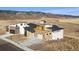 Captivating aerial view of luxury homes in a scenic landscape with mountains and open fields at 5741 Doc Bar Circle, Larkspur, CO 80118