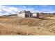 Breathtaking aerial view capturing a sprawling estate with luxurious homes and vast open fields at 5741 Doc Bar Circle, Larkspur, CO 80118